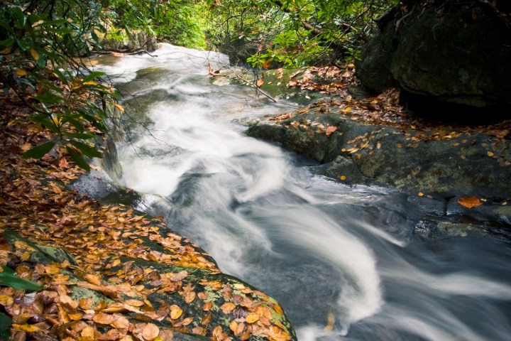 a large waterfall over some water
