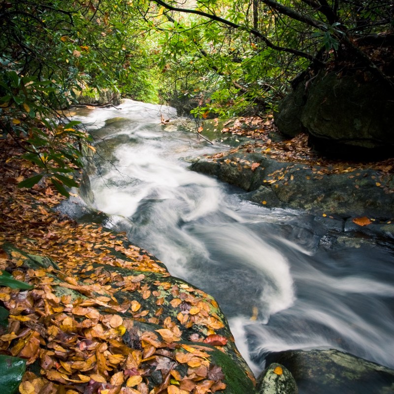 a large waterfall over some water