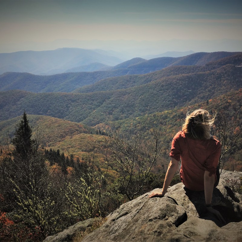 Hiker taking a mountaintop break on an Asheville tour