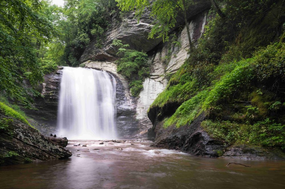 a large waterfall over a body of water