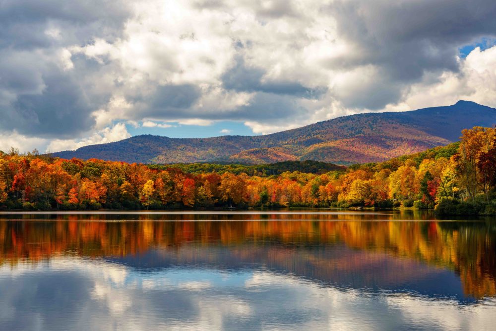 a body of water with a mountain in the background