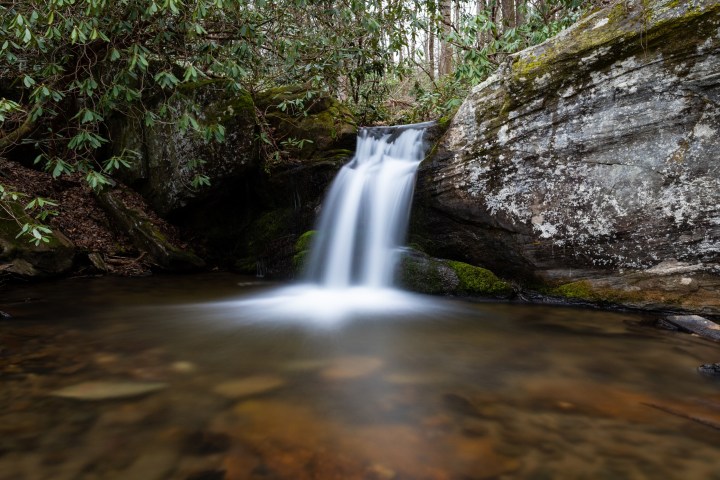 a large waterfall over some water