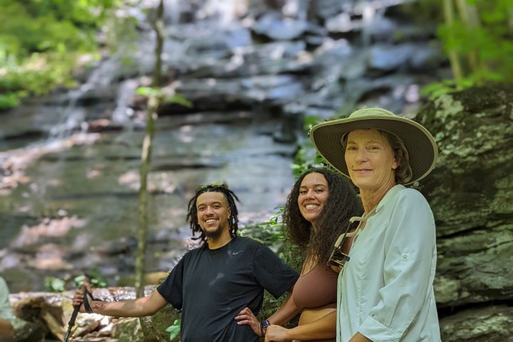 a group of people sitting on a rock