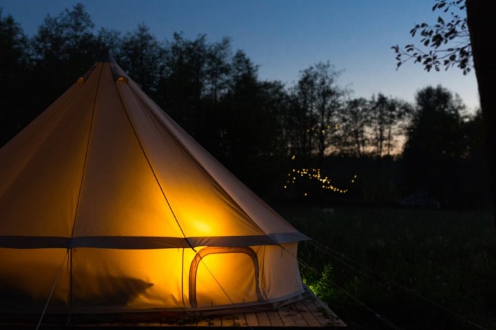a sunset over a tent