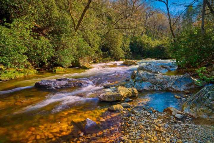 a waterfall going over a body of water