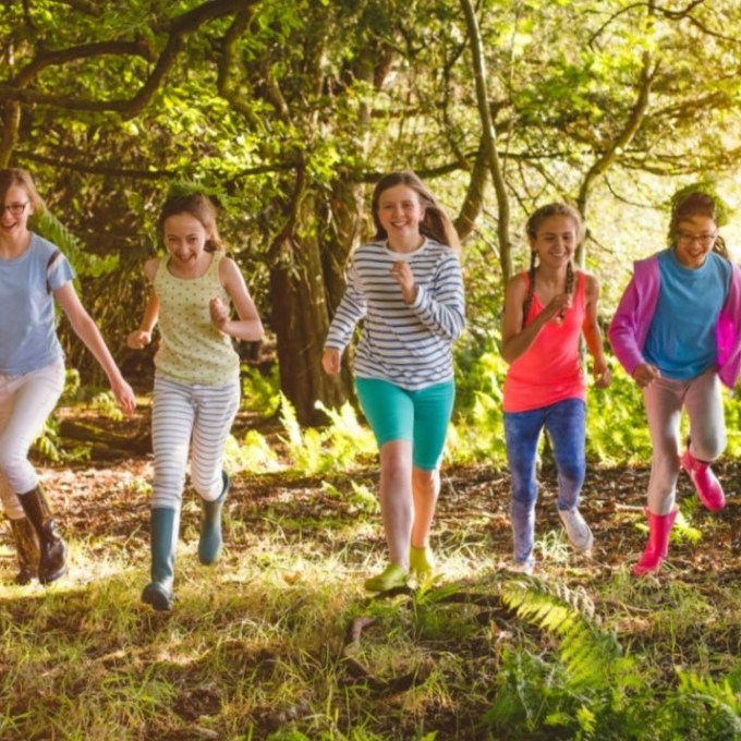 a group of people standing next to a tree