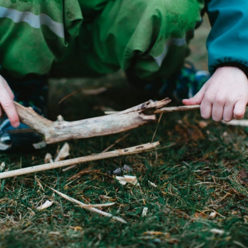 a little boy that is standing in the grass