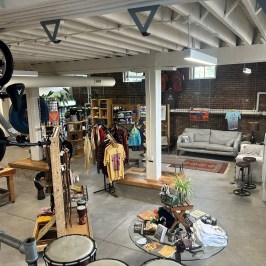a group of people standing in front of a shop